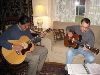 Jamie Harvey playing guitar with a friend