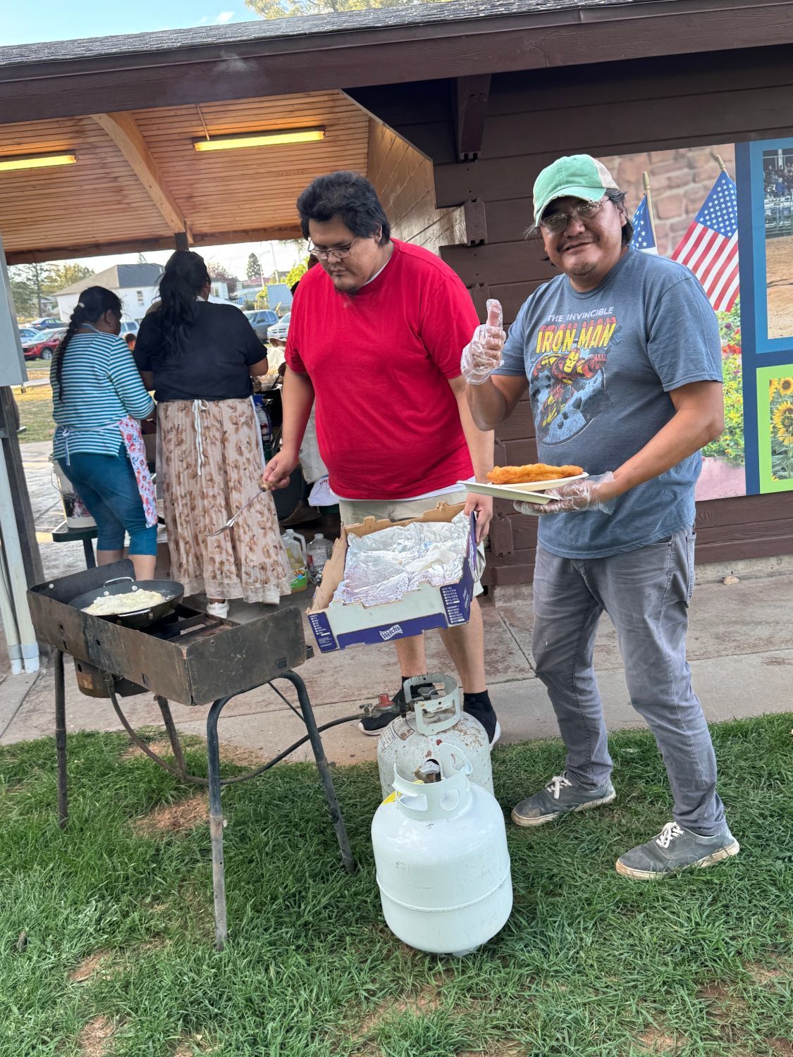 Volunteers frying bread at a community cookout